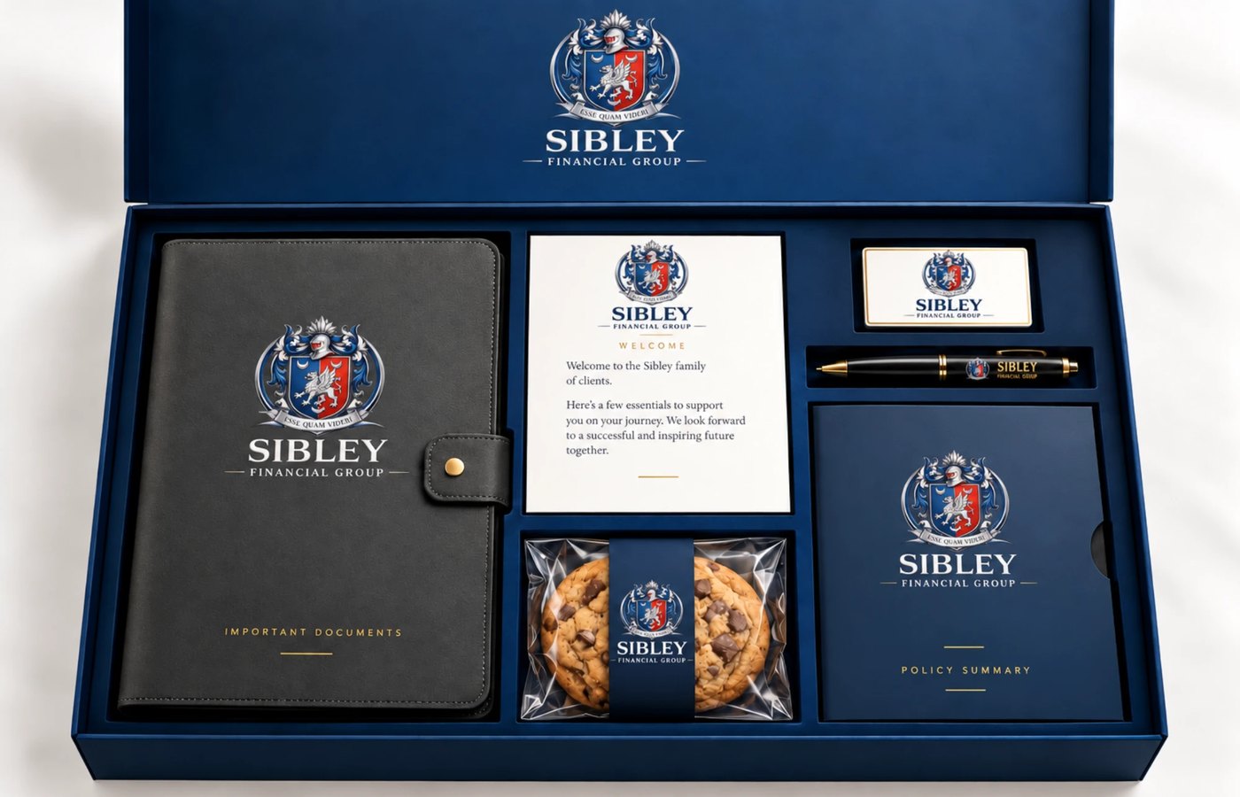 The Sibley Financial Group welcome box: a crest-embossed document portfolio, a welcome card, a policy summary folder, a branded pen, a business card and a cookie, set in a navy presentation case.